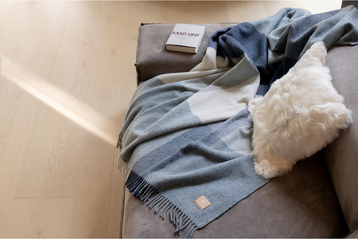 ALPAKA Classic Check recycled alpaca wool throw draped over a sofa