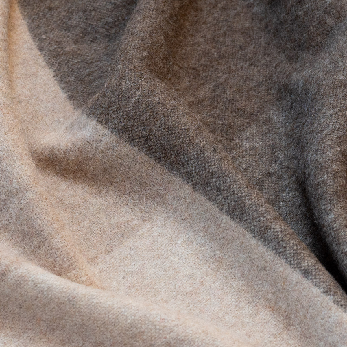 Close-up of the ALPAKA Classic Check throw showing its woven check pattern
