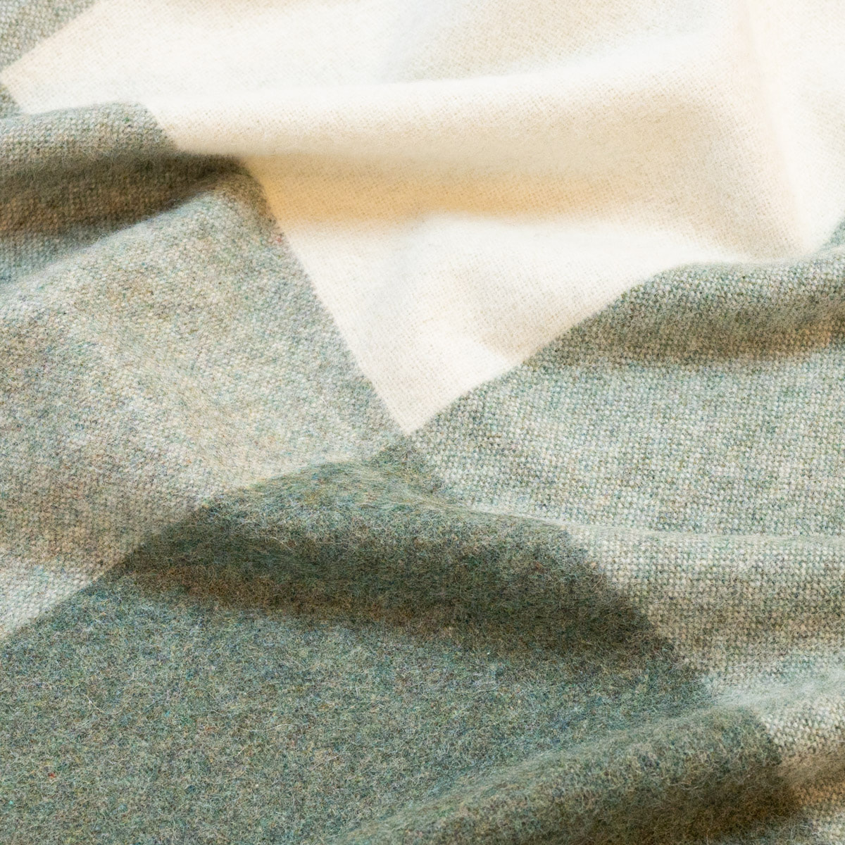Close-up of the Green ALPAKA Classic Check throw showing its woven check pattern